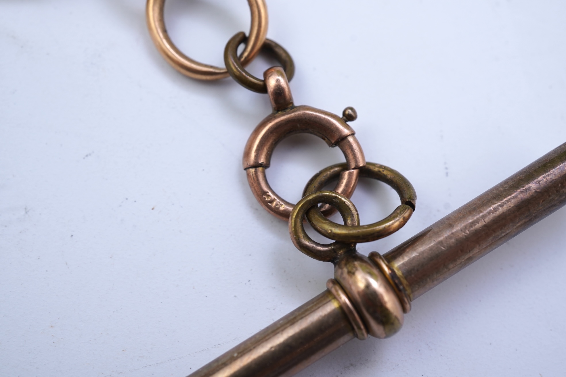 A continental 18k gold open faced keyless lever pocket watch, with a 9ct albert